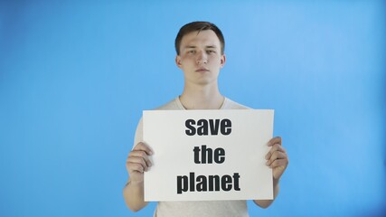 Young Man Activist With Save The Planet Poster on blue background