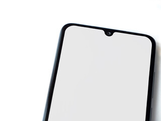 Black mobile smartphone mockup lies on the surface with blank screen isolated on white background