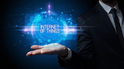 Man hand holding INTERNET OF THINGS inscription, technology concept