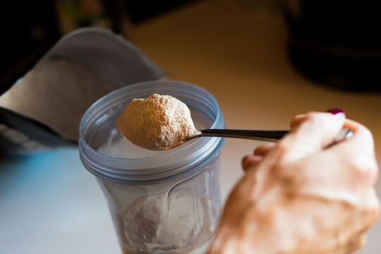 Girl's Hands With Vitiligo Making A Protein Shake After Sport