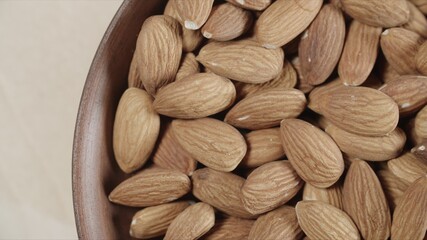 Closeup roasted almonds in wooden bowl