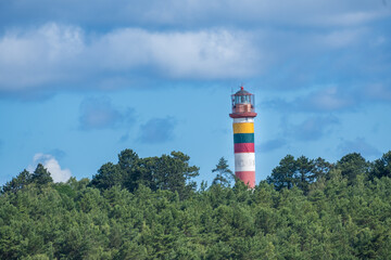 Fototapeta na wymiar Lighthouse, Nida, Neringa, Lithuania, in the Curonian Spit National Park between the Curonian Lagoon and the Baltic Sea, close to the Russian (Kaliningrad exclave) border.