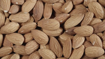 Closeup roasted almonds in wooden bowl
