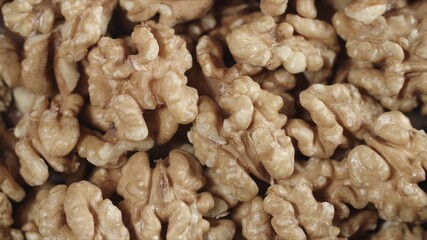 Dry walnut background, close up nut, rotation top view. Food background