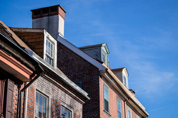 old brick building with blue sky and windows