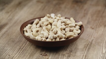 Bowl with almonds on wooden table