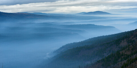 Misty mountain valley in the morning. Panoramic view from Green Ridge Lookout in Central Oregon.