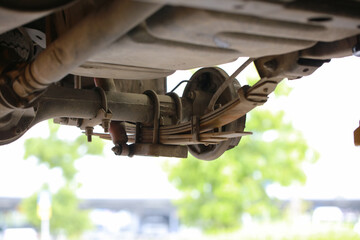 Fototapeta Vehicle maintenance, repair rear suspension and drive shaft of pick up truck obraz