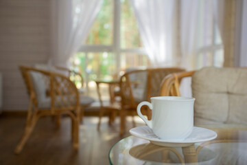 White Cup and rattan furniture on the summer porch.