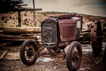 Fototapeta na wymiar Vintage Tractor at an Old Log Mill
