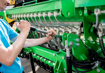 The mechanics repair combine harvester. Modern agricultural machinery
