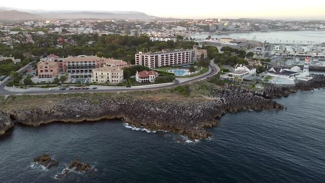 Amazing aerial view at sunset of the little village of Cascais not far from Lisbon in Portugal. The landscape of the city near to the Ocean.  The shoreline to the west has cliffs, attracting tourists.