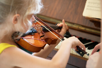 little girl learn to play small violin, suzuki lessons, horizontal shape, music lesson