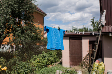 children shirt is drying on a rope outside