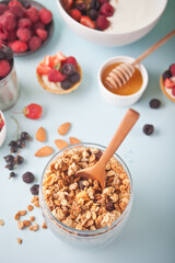 Healthy oat granola muesli cereals in a jar with fresh berries