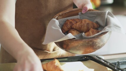 Close up of cooked croissants in wooden bowl
