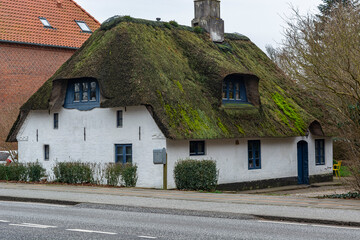 Fototapeta na wymiar old apartment building, thatched roof. Housing in Europe