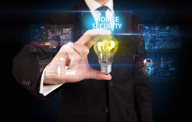 Businessman holding lightbulb with MOBILE SECURITY inscription, online security idea concept