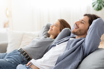 Young chilling couple enjoying day off at home