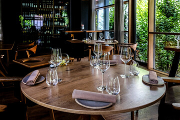 Modern scandinavian farmhouse contemporary rustic restaurant interior with wine glasses, selective focus