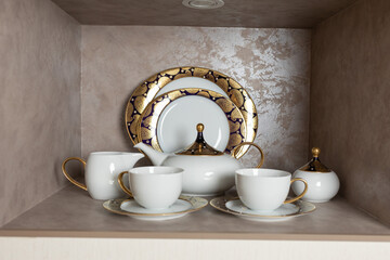 Set of clean tableware, dishes, plates, utensils, cups on the table