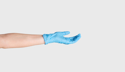 Concept of medical donation. Closeup of outstretched female hand in rubber glove on white background, copy space