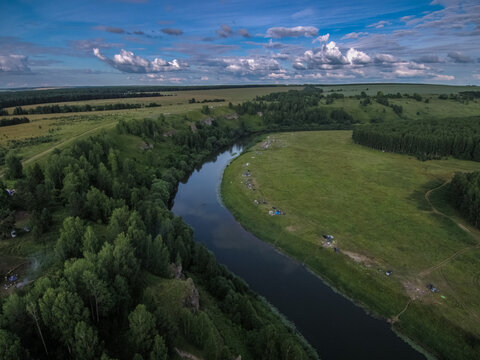 on the banks of the Nemda River there are many tents with tourists