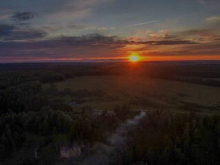 The setting sun illuminates the Chembulat nature reserve on the banks of the Nemda River