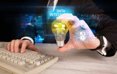 Businessman holding lightbulb with DATA INTEGRATION inscription, online security idea concept