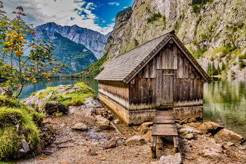 Beautiful house at the lake Obersee and green mountains in bavaria, germany in the summer.