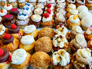 Selection of delicious muffins with toppings