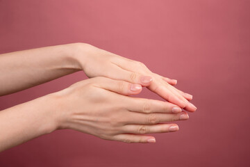 wrist on pink background, caring for  skin of  hands, delicate young skin, aging hands, beautiful manicure, self-care, young body,