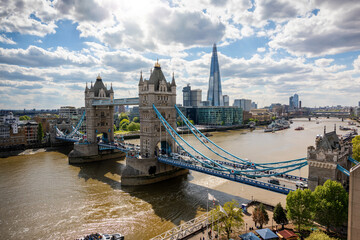 Beautiful view to the Tower Bridge and modern skyline of London along the Thames river on a sunny day, United Kingdom