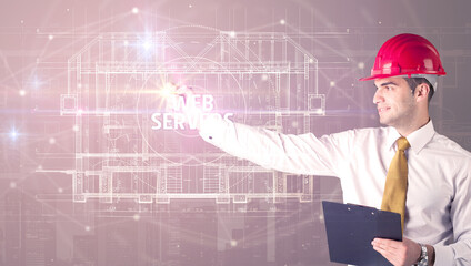 Handsome architect with helmet drawing WEB SERVERS inscription, new technology concept
