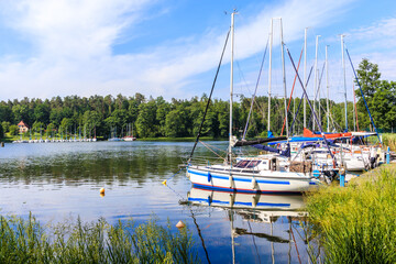 Sailboats reflection in lake Nidzkie near Ruciane Nida town, Mazury Lake District, Poland - obrazy, fototapety, plakaty