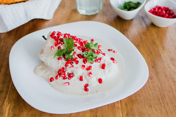 chiles en nogada, traditional Mexican dish with poblano chili peppers and walnut sauce from Puebla Mexico