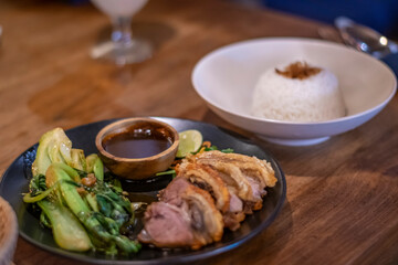 Traditional indonesian pork chops served with vegetables and rice during candle light dinner