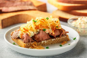 Rye bread sandwich with roast beef, fried onions, mayonnaise and remoulade sauce. Danish gourmet snacks