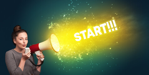 Young woman yelling to loudspeaker with START!!! inscription, modern media concept
