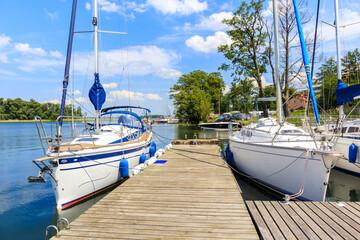 Sailing boats anchoring at pier of Lake Beldany in port Wierzba on summer sunny day, Mazury Lake District, Poland © pkazmierczak