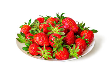 Ripe, red strawberries with green leaves in a white plate on a white background