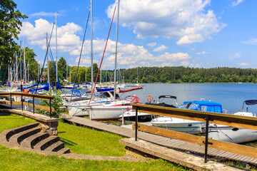 Sailing boats anchoring at pier of Lake Beldany in port Wierzba on summer sunny day, Mazury Lake District, Poland © pkazmierczak