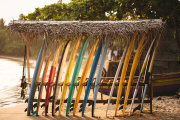 Sri Lanka, Galle. Surfboards in warm sunset light against the backdrop of ocean waves. Surfboards...