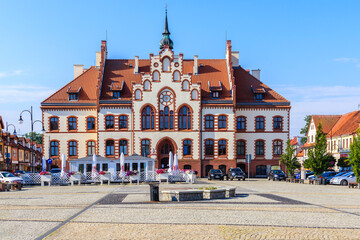 PISZ TOWN, POLAND - JUN 27, 2020: Town hall on square in Pisz town, Masurian Lakes region, Poland. - obrazy, fototapety, plakaty