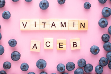  Vitamin word  A C E B on pink background, Health concept.Berry vitamin