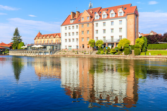 Reflection of historic buildings in Pisa river in Pisz town, Masurian Lakes region, Poland