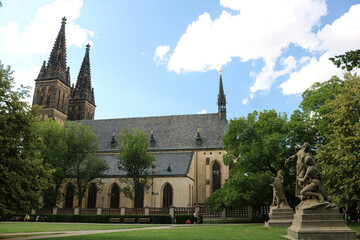 Statues in the Visegrad garden against the background of the Basilica of Saints Peter and Paul in Prague on a hot, Sunny summer day