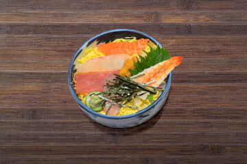 Japanese dish called Donburi Kaisendon.  Assorted sashimi rice bowl with shrimp, tuna, salmon and egg.