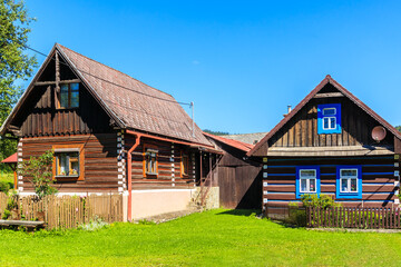 Old traditional rural wooden houses in Osturnia village in Tatra Mountains on beautiful summer sunny day, Slovakia