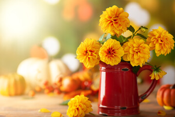 Autumn floral still life with beautiful yellow dahlia in vintage red jug and pumpkins on the table. Autumnal festive concept. - obrazy, fototapety, plakaty